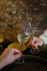 Tasting of grand cru sparkling white wine with bubbles champagne by old champagne caves in grand cru wine producer small village Cramant, Champagne, France