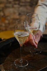 Tasting of grand cru sparkling white wine with bubbles champagne by old champagne caves in grand cru wine producer small village Cramant, Champagne, France
