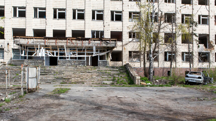 Destroyed administrative building in Ukraine. The damaged facade of the building of the regional state administration after the shelling of Russian missiles. Destroyed infrastructure of the city.