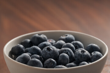 Fresh washed blueberris in white bowl on linen cloth