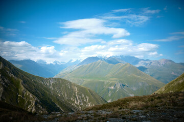 Mountain ranges on a sunny day at Georgia. Sky with clouds adn hills
