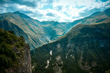 Mountain ranges on a sunny day at Georgia. Sky with clouds adn hills