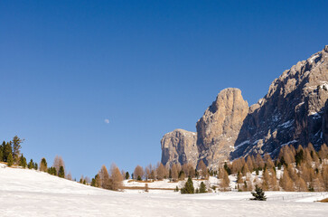 Mountain ski slope. Italian alps. Skiers enjoying last remaining bits of snow in melting late...