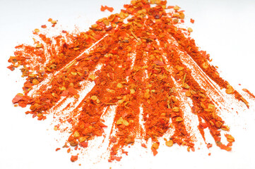 Red hot chili ground pepper spread on a white background