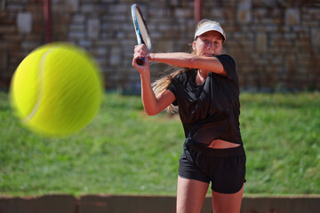A professional female tennis player serves the tennis ball on the court with precision and power