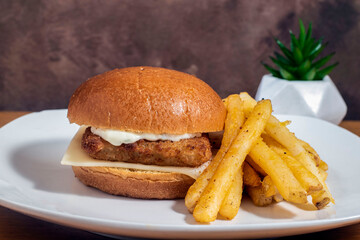 fish sandwich top with tarter sauce  and swiss cheese