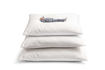 Mature man in pyjamas lying on a pile of pillows