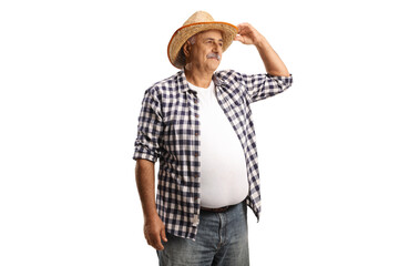 Mature farmer with a straw hat looking in distance