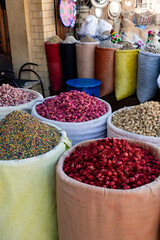 Spices in colorful bins in a store in the streets of the Marrakech Medina in Morocco