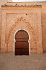 Beautiful moorish arch door entrance to a mosque in the  Marrakech Medina of Morocco