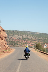 A man riding motorcycle in the roads of the mountains of the Ourika Valley in Morocco