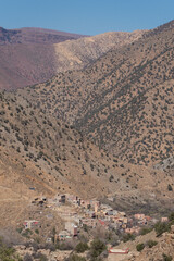 A town sits on the skirts of the mountains of the Ourika Valley in the High Atlas of Morocco