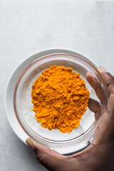 Cheddar cheese powder in a glass bowl, orange cheese power, dehydrated cheddar cheese for making cheese popcorn