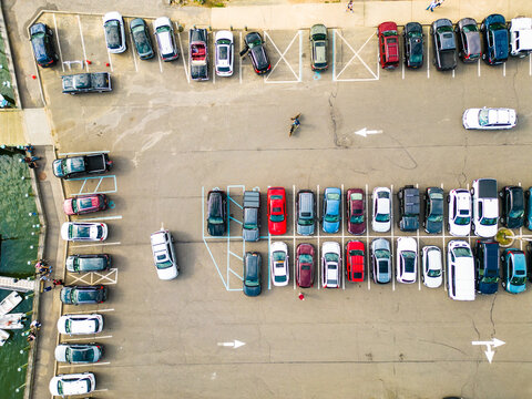 Parking lot with cars as seen from aerial overhead view