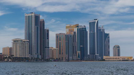 Fototapeta premium Sharjah city view, high rise buildings with lagoon