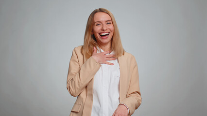 Amused office secretary woman looking to camera, laughing out loud, taunting making fun of ridiculous appearance, funny joke anecdote. Business girl isolated alone on gray studio background - obrazy, fototapety, plakaty