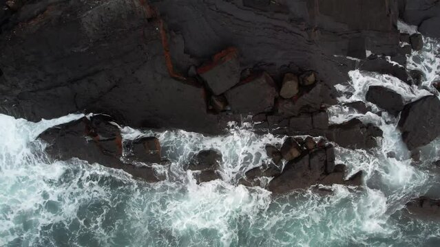 Prise de hauteur avec le drone qui monte en altitude et r&eacute;v&egrave;le le paysage rocailleux du littoral atlantique au nord de l'Espagne