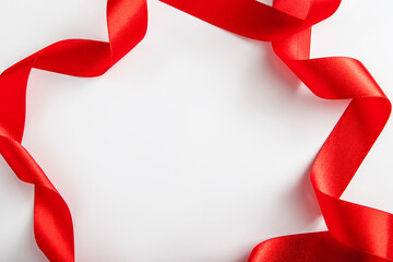 Red silk ribbon for wrapping gifts on white background.