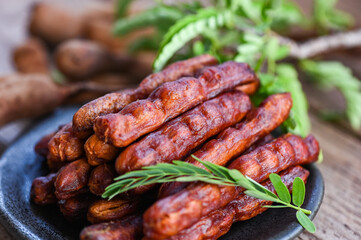 Tamarind sweet for food fruit ripe tamarinds on plate and white background, Tamarind peel in plate tropical fruits summer - top view