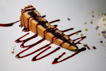 Tasty italian dessert, hot chocolate cake with sweet sauce and nuts