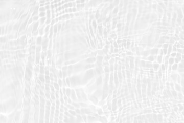 White water with ripples on the surface. Defocus blurred transparent white colored clear calm water surface texture with splashes and bubbles. Water waves with shining pattern texture background.