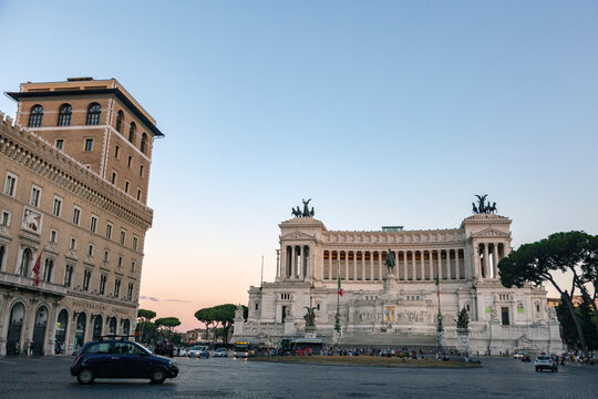 A Car Drives Past A Building In Rome