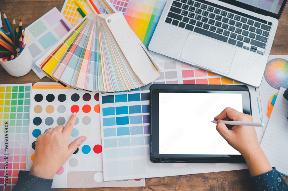 Fototapete Graphic designer architects who work with laptops and color comparison tables for design work..