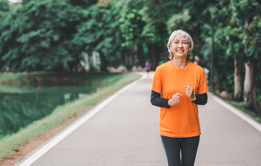 white-haired elderly person exercising in the park early in the morning.