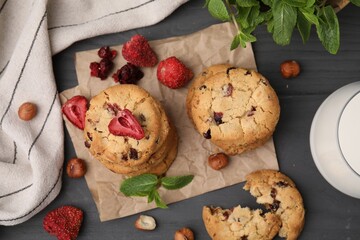 Cookies with freeze dried fruits, mint and nuts on grey table, flat lay