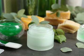 Homemade cosmetic products, fresh ingredients and brush on black table, closeup