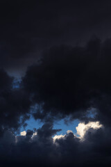 Epic Storm sky, dark grey black and white rain cumulus clouds with blue sky background texture