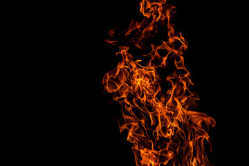 Fire flame against black background, abstract texture, copyspace