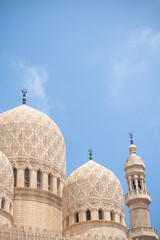 White mosque with domes in Cairo Egypt with beautiful geometric patterns and carvings