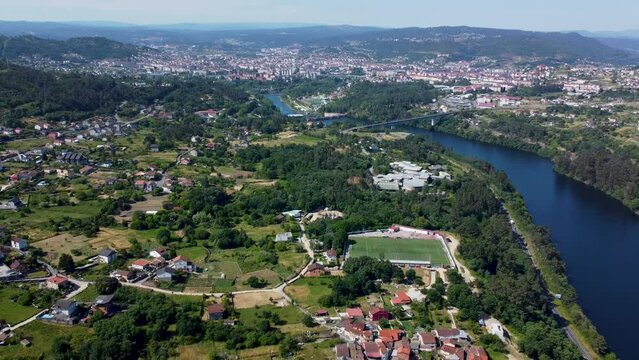 Aerial reverse dolly along river and forest of ourense and velle in spain