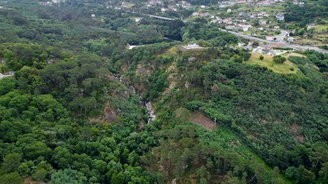 Deep river gorge in forest fronts rural countryside in ourense spain, aerial