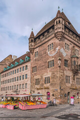 Fototapeta na wymiar The main market, at the central square in the old town on the right side of the Pegnitz river in Sebalder Altstadt. The weekly market takes place every weekday on open space. Nuremberg, 2018