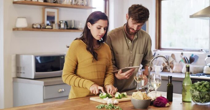 Tablet, recipe and online cooking couple search tutorial together in the home or house kitchen using an app. Happy, internet and people learning a healthy vegetable diet or meal for lunch or dinner