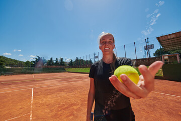 Before her training, the tennis player joyfully playing with a tennis ball, radiating enthusiasm...