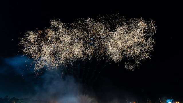 fireworks on a black background Frame or border from golden sparks and firecrackers isolated on new year night fireworks and bokeh lights on dark blue night sky background.