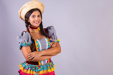 Brazilian woman, clothes from Festa Junina, Arraial, Festa de Sao Joao. crossed arms.