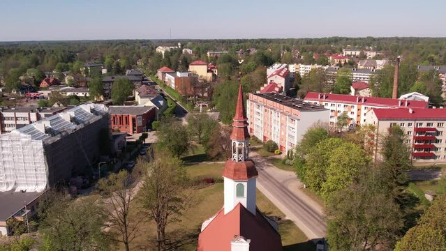 A small border town in Latvia. Valka city at sunset. Drone flight over the city