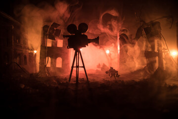 Action (War) movie concept. Man moving out with little boy from burned out city destroyed in war. Military fighting silhouettes.