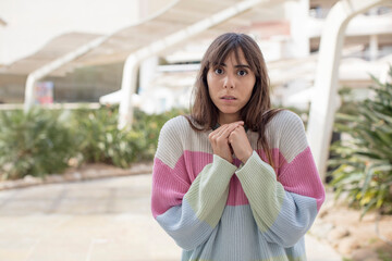 pretty young woman looking worried, stressed, anxious and scared, panicking and clenching teeth