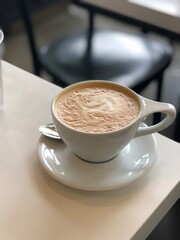 latte in white cup and saucer on white table in cafe, coffee, cup