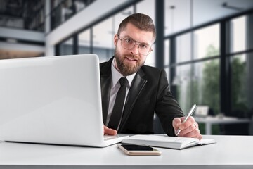 Fototapeta premium Mature businessman doing paperwork in office
