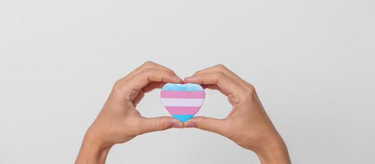 Fototapeta na wymiar Transgender Day and LGBT pride month, LGBTQ+ or LGBTQIA+ concept. hand holding blue, pink and white heart shape for Lesbian, Gay, Bisexual, Transgender, Queer and Pansexual community