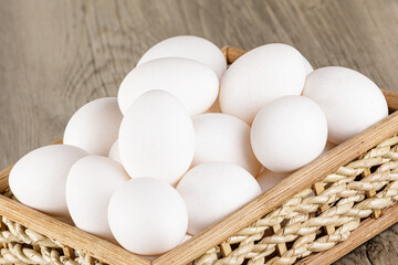Close up of  a basket of fresh raw White Eggs