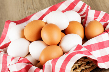 A basket of fresh raw White and Brown Eggs
