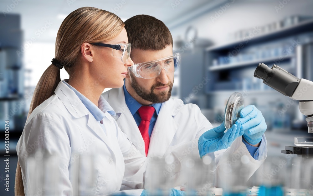 Poster young scientist work with microscope for test at laboratory.
