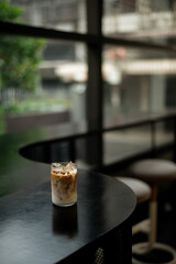 Fototapeta na wymiar Coffee cup on black table in coffee shop